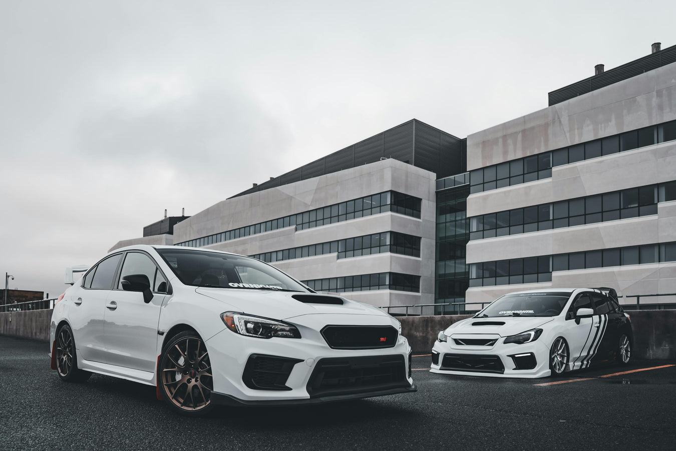 TWO WHITE SUBARU CARS